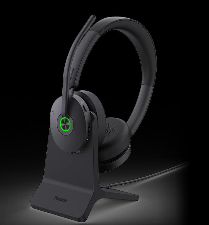 Yealink BH74 ANC Bluetooth wireless headset on the optional charging stand, studio view