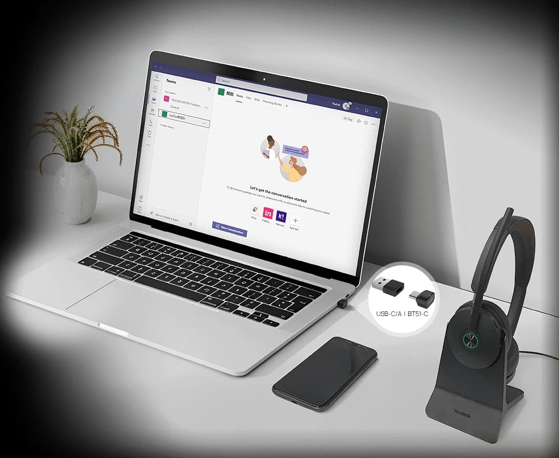 Yealink BH74 headset on a desk connected to a laptop running Microsoft Teams