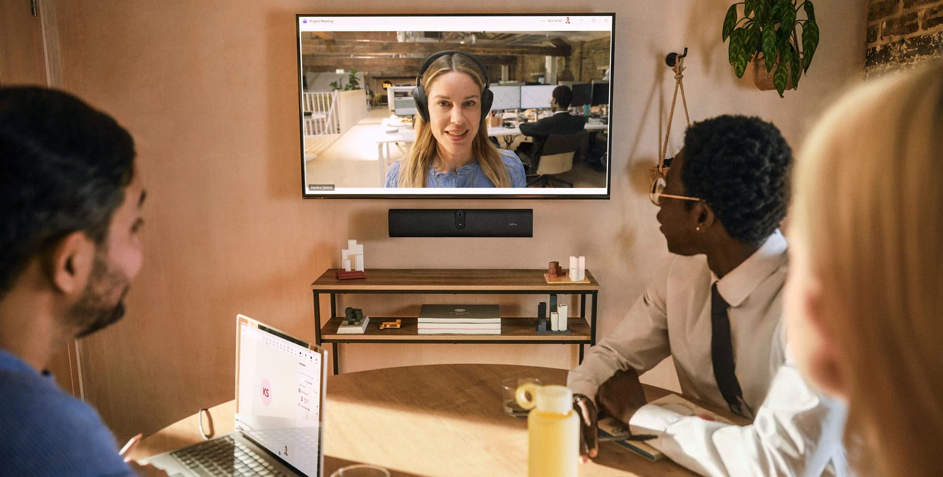 Jabra PanaCast U30 wall-mounted below a display in a meeting room