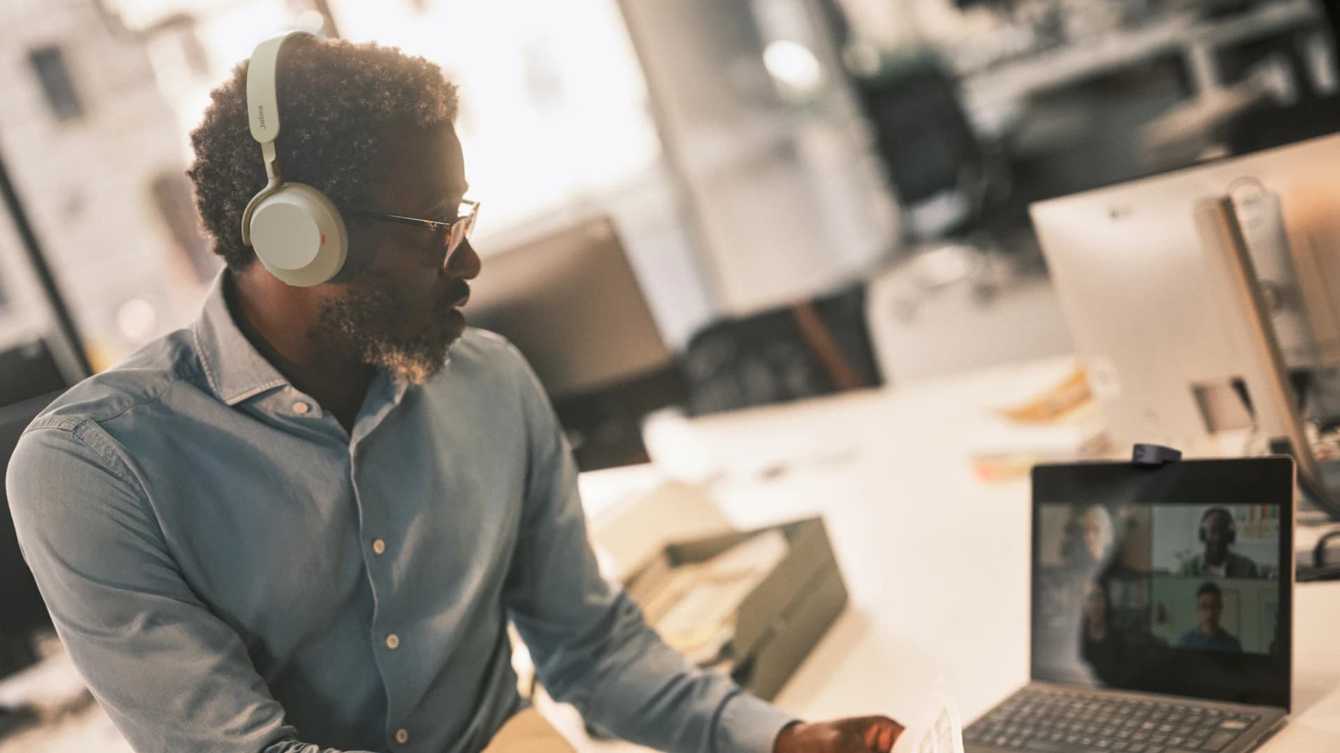 Jabra Evolve3 75 headset worn on a video call at a laptop